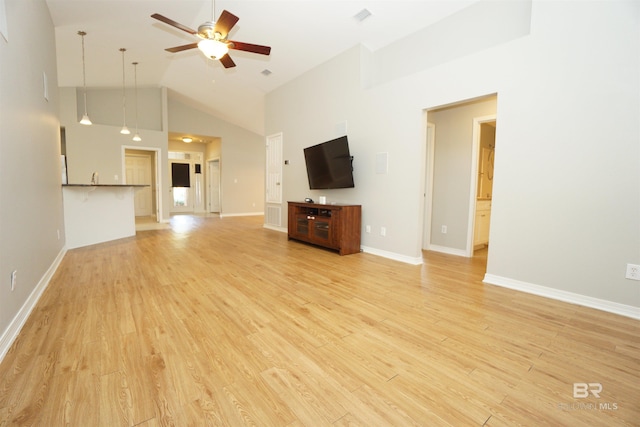 unfurnished living room with ceiling fan, high vaulted ceiling, and light hardwood / wood-style floors