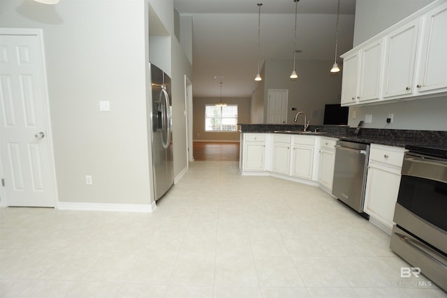 kitchen with white cabinetry, sink, hanging light fixtures, kitchen peninsula, and appliances with stainless steel finishes