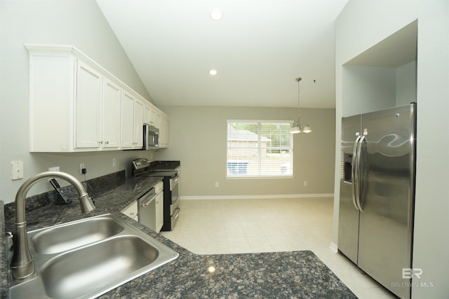 kitchen with lofted ceiling, sink, light tile patterned floors, appliances with stainless steel finishes, and white cabinetry