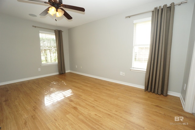 spare room with ceiling fan and light wood-type flooring