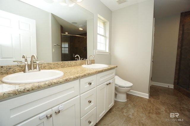 bathroom featuring vanity, toilet, and a shower with door