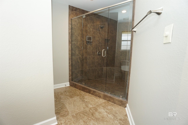 bathroom with a shower with door