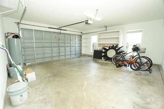 garage featuring water heater and a garage door opener