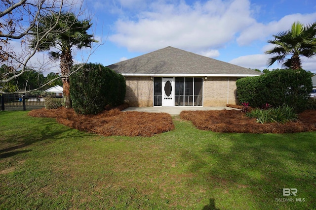 back of property featuring a lawn