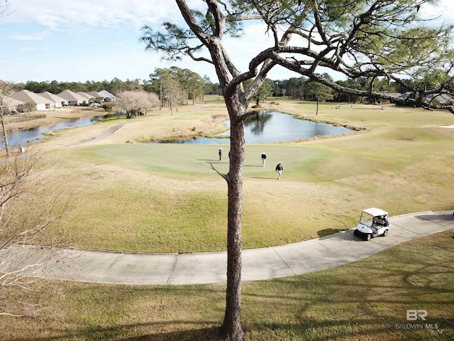 surrounding community with a yard and a water view