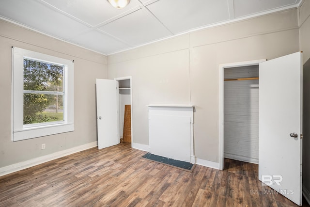 unfurnished bedroom with a closet and dark wood-type flooring