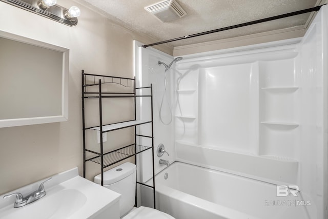 full bathroom featuring tub / shower combination, a textured ceiling, vanity, and toilet