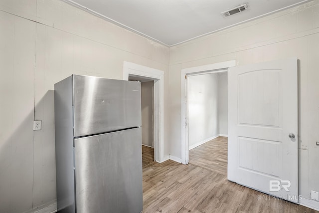 401 Gaston St, Mobile, AL 36603 - kitchen with visible vents, light wood-style floors, and freestanding refrigerator