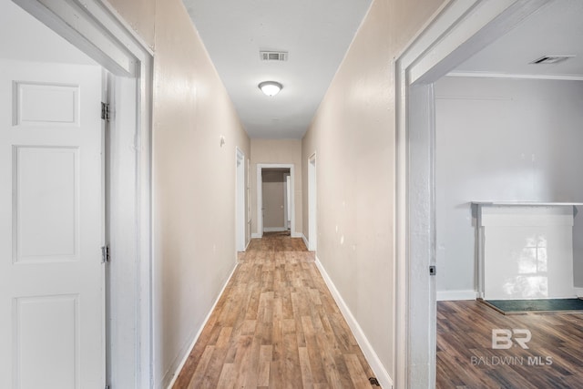 hallway with light hardwood / wood-style flooring