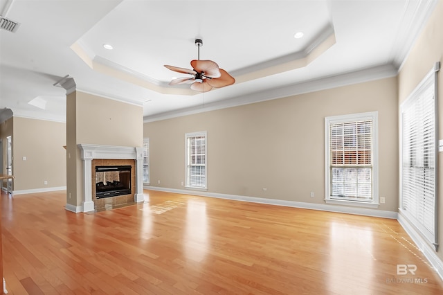 unfurnished living room featuring a multi sided fireplace, crown molding, ceiling fan, and light hardwood / wood-style floors