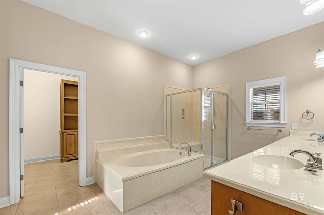 bathroom with tile patterned floors, vanity, and shower with separate bathtub