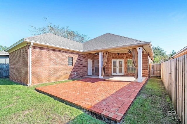 rear view of house featuring french doors, a yard, and a patio