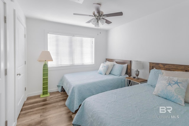 bedroom with ceiling fan and light wood-type flooring