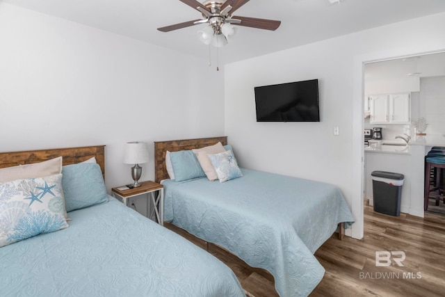 bedroom with hardwood / wood-style floors and ceiling fan