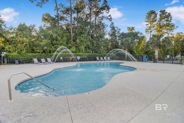 view of swimming pool with a patio area and pool water feature