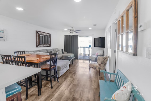 living room featuring hardwood / wood-style floors and ceiling fan