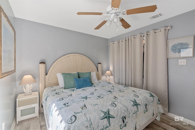 bedroom with ceiling fan and light wood-type flooring