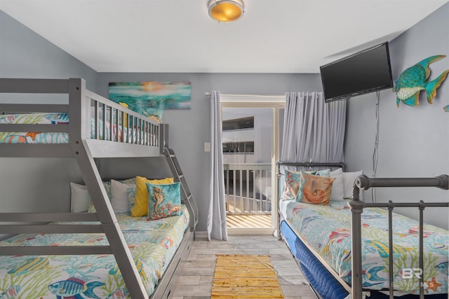 bedroom featuring access to exterior and light hardwood / wood-style floors