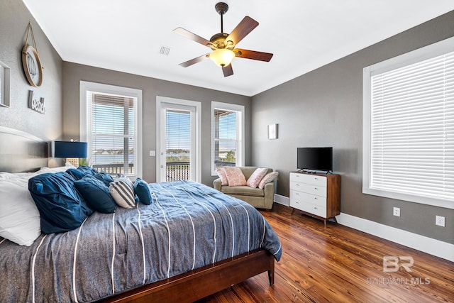 bedroom with access to outside, dark hardwood / wood-style flooring, and ceiling fan