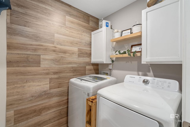 laundry area with cabinets and separate washer and dryer