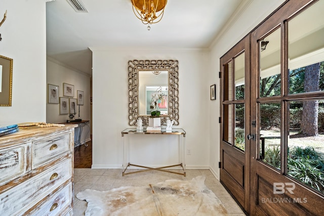 foyer entrance with baseboards, visible vents, crown molding, and light tile patterned flooring