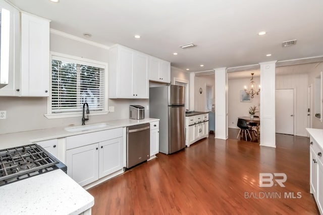 1 Elizabeth Pl, Mobile, AL 36606 - kitchen with stainless steel appliances, a sink, white cabinets, dark wood finished floors, and recessed lighting
