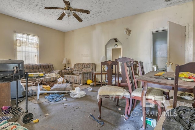 1310 Hercules St, Mobile, AL 36603 - carpeted living area featuring a ceiling fan, a textured ceiling, and arched walkways