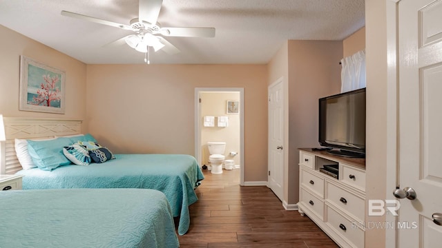 bedroom with ceiling fan, ensuite bath, dark hardwood / wood-style floors, and a textured ceiling