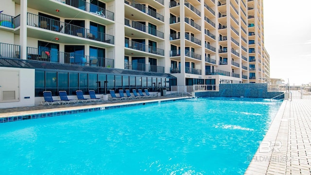 view of swimming pool with pool water feature