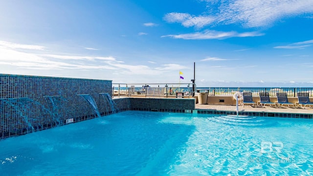 view of pool with a water view