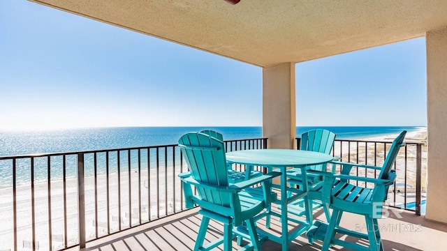 balcony featuring a beach view and a water view