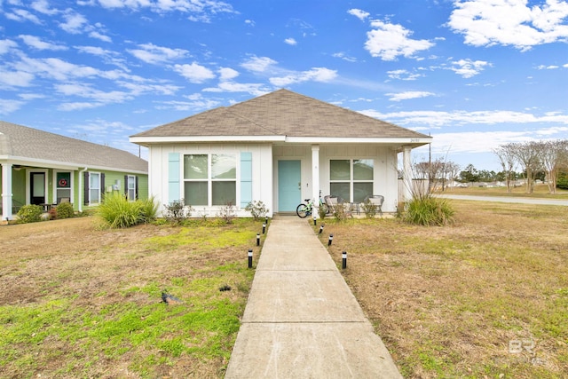 bungalow-style home with a front lawn