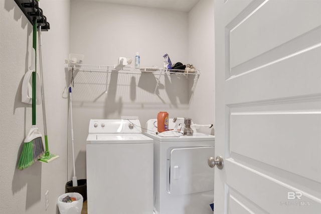 clothes washing area with washing machine and clothes dryer