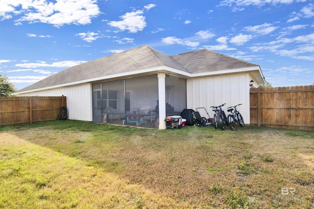 rear view of house with a lawn