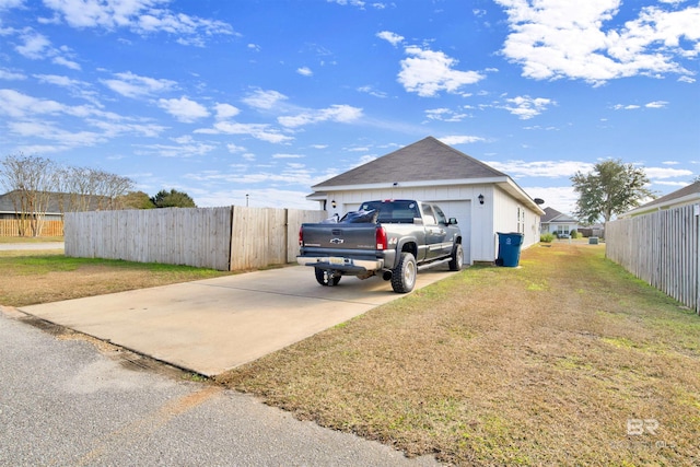 view of property exterior with a yard and a garage