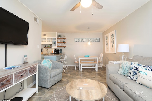 living room with ceiling fan and sink