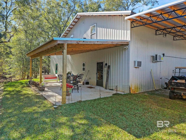 rear view of property featuring a yard and a patio