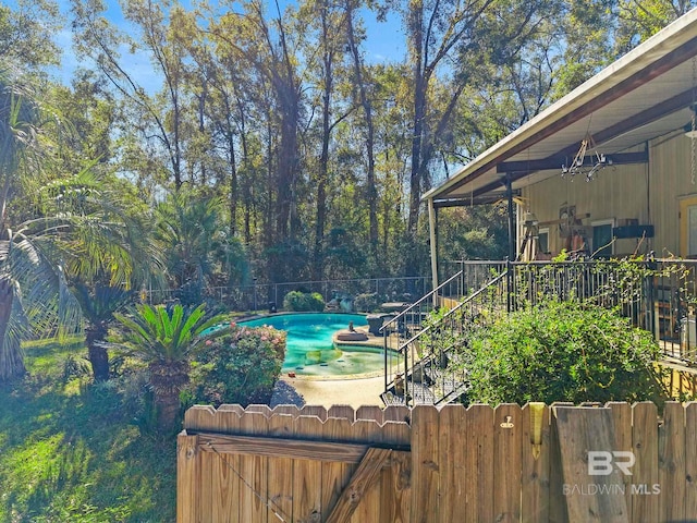 view of yard with a fenced in pool and ceiling fan