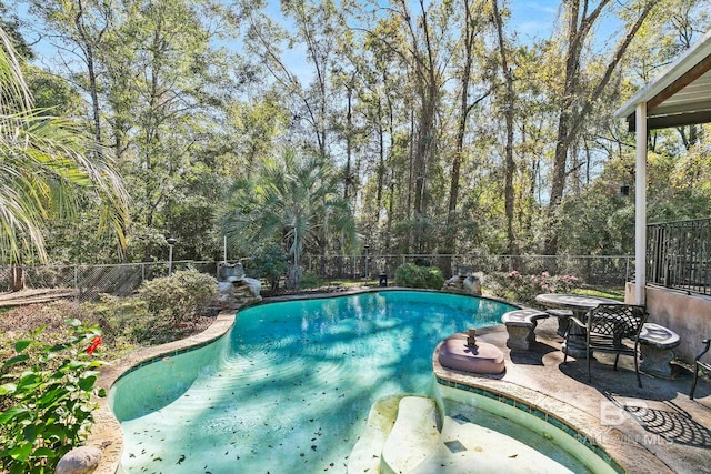 view of swimming pool with a patio area