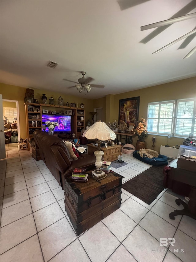 living room featuring ceiling fan and light tile patterned flooring