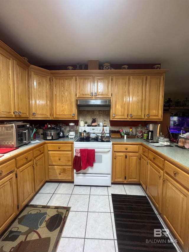 kitchen with light tile patterned floors and white electric range