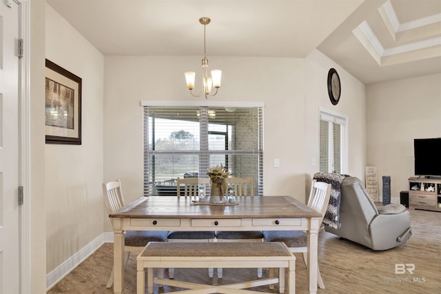 dining room with wood-type flooring and an inviting chandelier