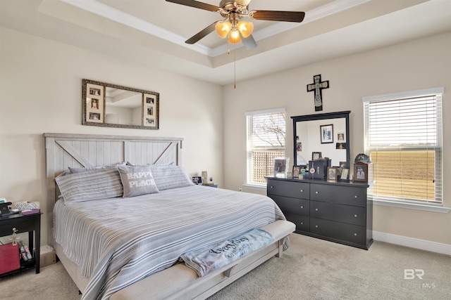 bedroom featuring light carpet, a raised ceiling, ceiling fan, and ornamental molding