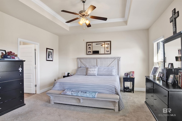 bedroom with ceiling fan, a raised ceiling, and light carpet