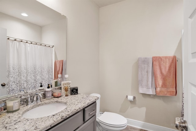 bathroom featuring vanity and toilet