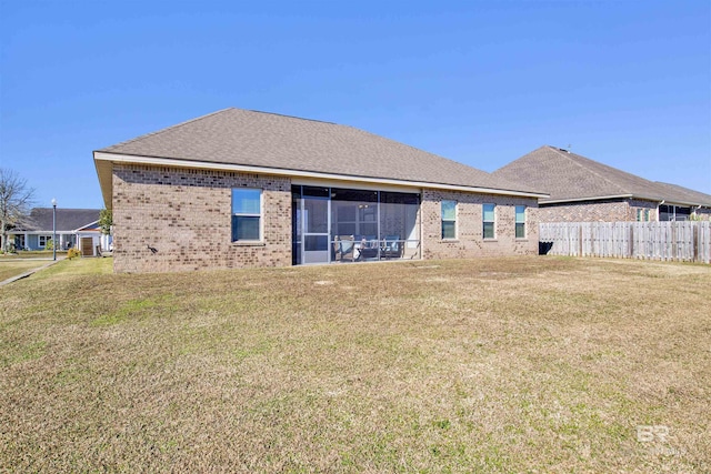 back of house featuring a sunroom and a yard