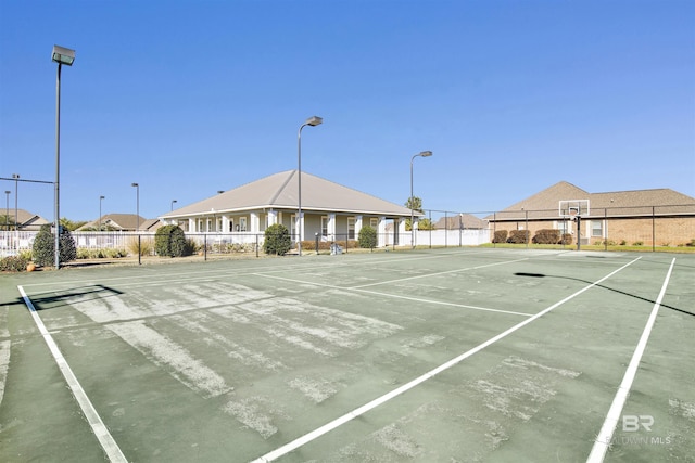 view of tennis court with basketball hoop