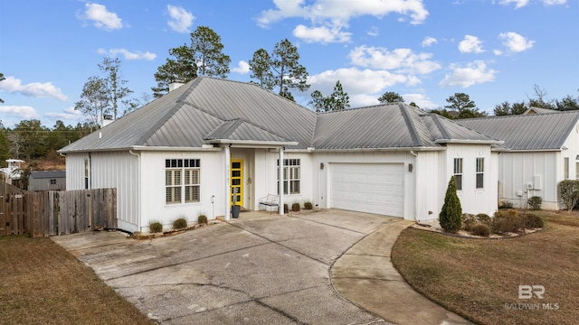 view of front of home with a front lawn and a garage