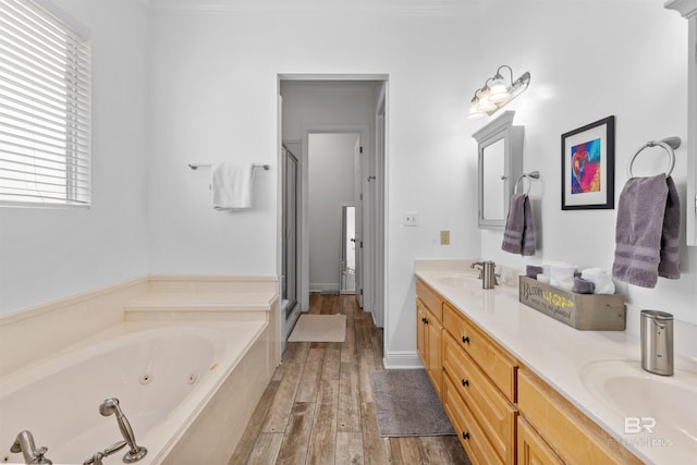 bathroom with shower with separate bathtub, vanity, and hardwood / wood-style flooring