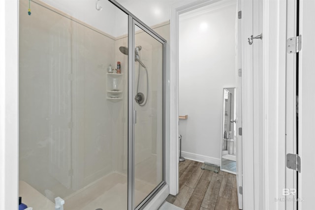 bathroom with hardwood / wood-style flooring and walk in shower